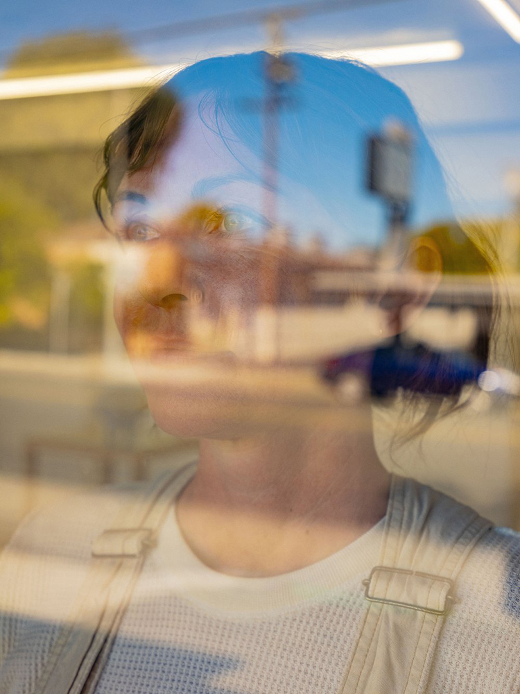 Portrait of Lisa Cralle taken through a window