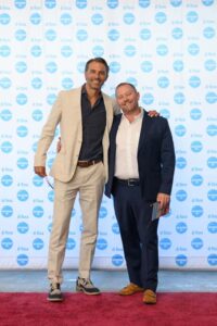 People standing in front of a "di Rosa" backdrop, smiling.