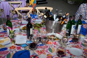 A table strewn with wine and food