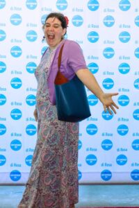 A person standing in front of a "di Rosa" backdrop, smiling.