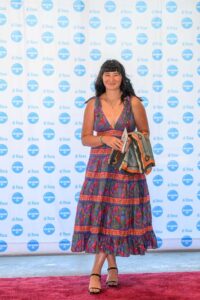 A person standing in front of a "di Rosa" backdrop, smiling.